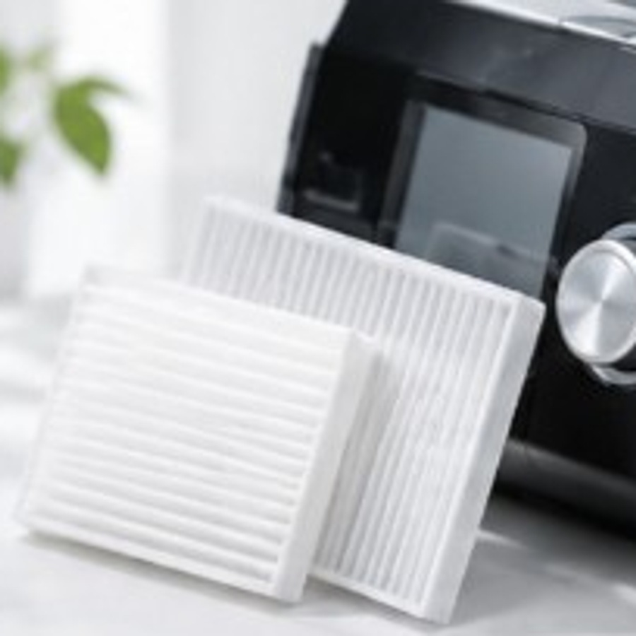 White CPAP replacement filters in front of a therapy machine